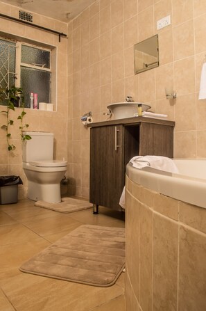 Bathtub, towels, soap, toilet paper