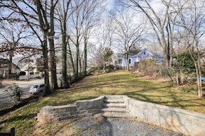 Stroll through a serene neighborhood with a well-manicured lawn and a gated property.