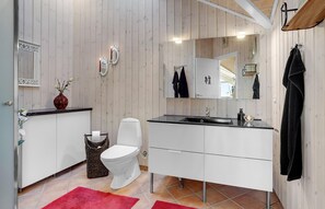 A modern bathroom with a white toilet, a black sink, and a large mirror above the vanity. - Amazing home in Hadsund with WiFi (Hadsund)