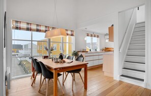 Enjoy meals in the spacious kitchen and dining area with a view of the outside through the large window.