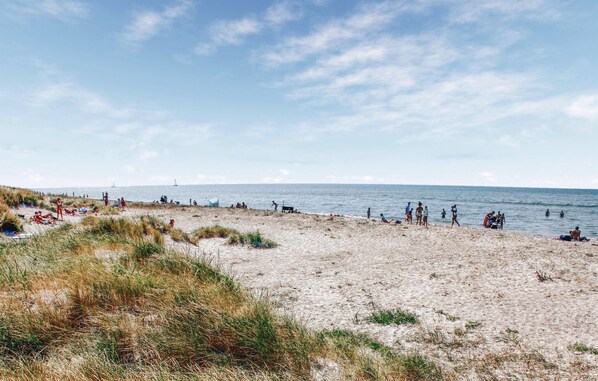 Guests can enjoy a serene beach experience with calm seas and scenic views.