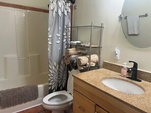 Combined shower/tub, hair dryer, towels, soap
