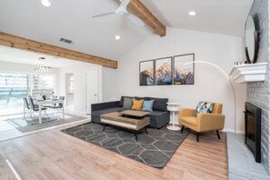 Smart TV, fireplace, books, computer monitors