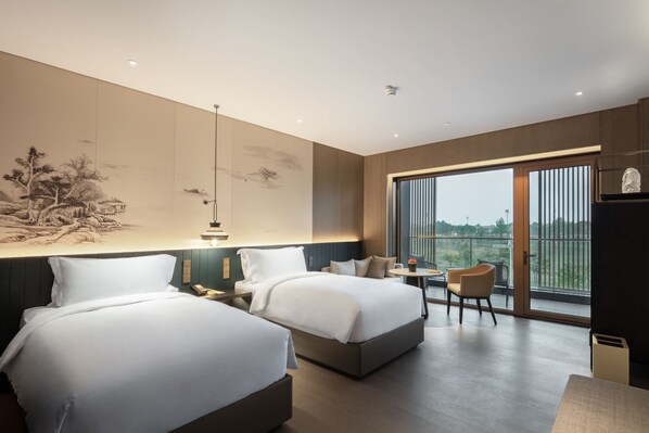 A modern hotel room with two beds, a dining area, and large windows offering a view of the outdoors. - Mhub by MGM Nanjing Jiangning (Nanjing)