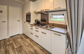 Fridge, stovetop, dishwasher, coffee/tea maker