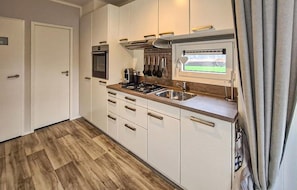 Fridge, stovetop, dishwasher, coffee/tea maker