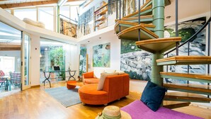 A spacious living area with a modern staircase, a comfortable seating area, and a view of the outdoors. - 3 bedroom amazing home in Dubrovnik (Dubrovnik)