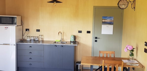 Microwave, cookware/dishes/utensils, dining tables
