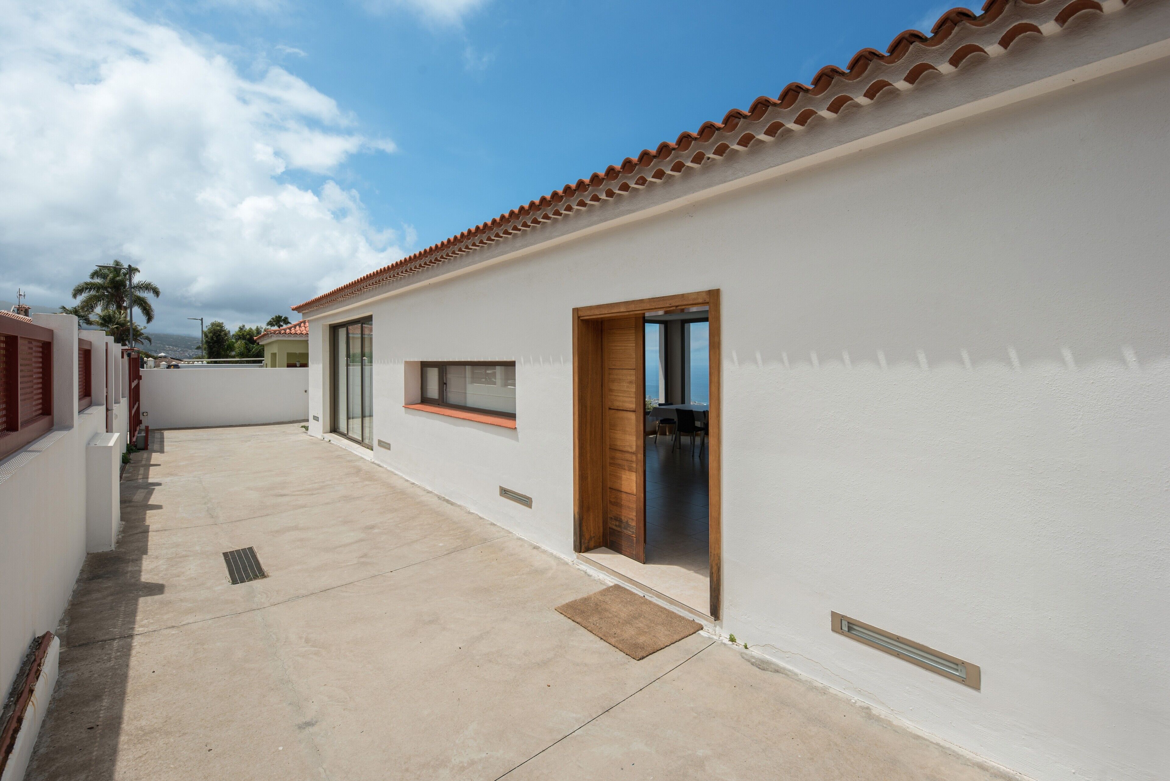 A building with a tiled roof, a door, and a window.