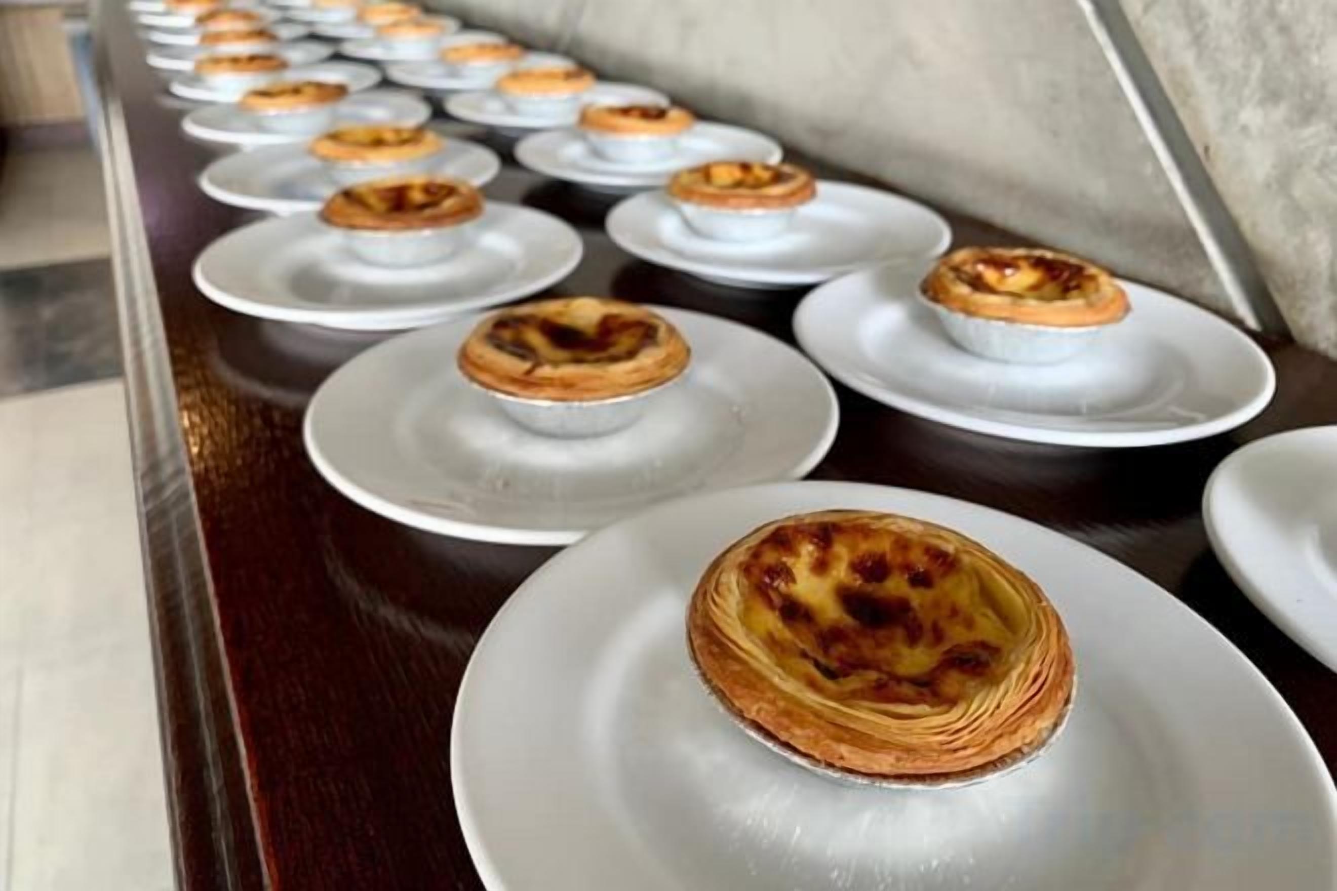 A row of plates with pastries, likely a buffet setting.