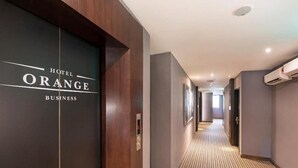A hotel corridor with a wooden floor and a sign reading "Hotel Orange Business". - Orange Business Hotel Petaling Jaya (Petaling Jaya)