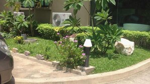 A landscaped garden with various plants and a lamp post.