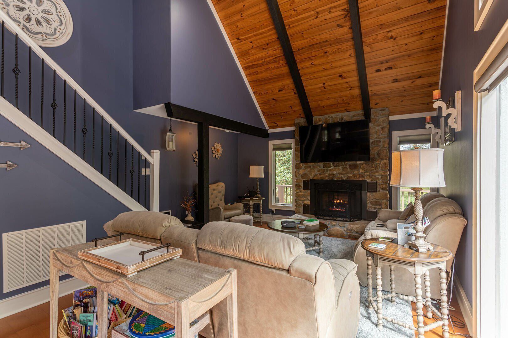 Gather around the glowing stone fireplace beneath soaring wood-beamed ceilings. Plenty of cozy seating for the whole crew at Linville Land Harbor.
