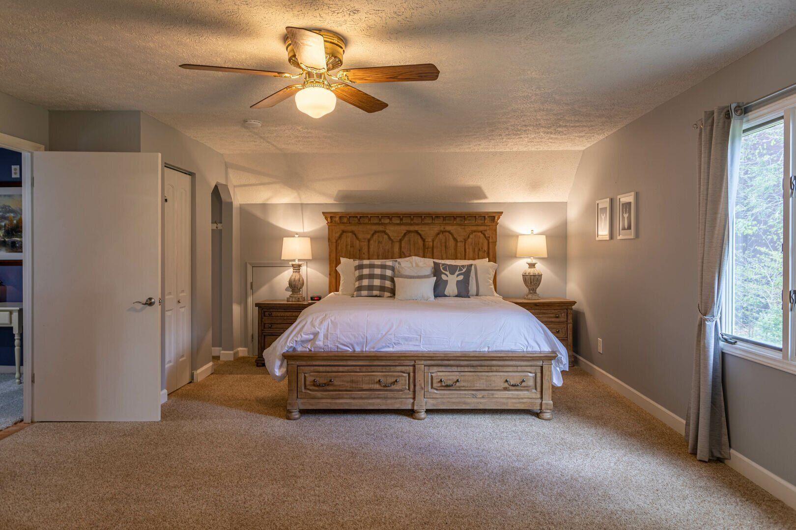 Rest easy in the spacious king master suite, where warm lighting and mountain-themed accents set a cozy Blue Ridge mood.