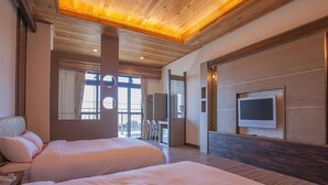 A hotel room with two beds, a TV mounted on the wall, and a large window with curtains. - Star Villa (Nantou)