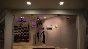 A modern hotel entrance with a 'Hollywood' sign, a welcome mat, and a zigzag patterned wall. - Hollywood Hotel (Ipoh)