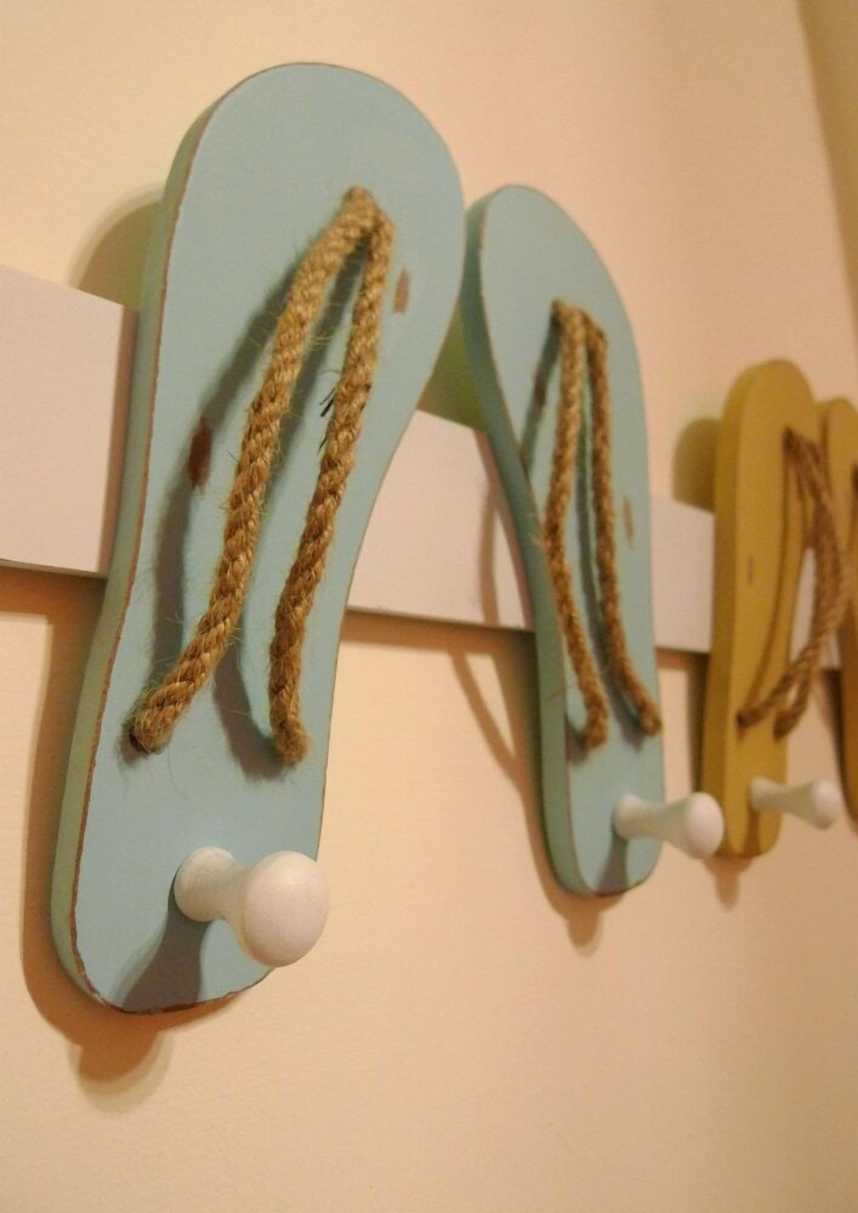 A pair of flip-flops hanging on a wall-mounted rack.