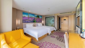 A hotel room with a large bed, a yellow armchair, and a painting of lavender fields on the wall. - Lavande Hotel (Foshan Shunde Jinlong Metro Station) (Foshan)