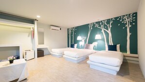 A modern bedroom with a large bed, a bedside table, a dresser, and a wall mural. - Reindeer Park Resort (Nakhon Nayok)