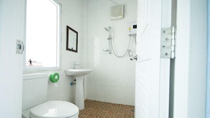 A small bathroom with a toilet, sink, and shower. - Hotel Viewpoint Khao Koh (Khao Kho)