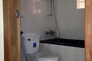 Ein kleines Badezimmer mit Toilette, Dusche und Waschbecken.