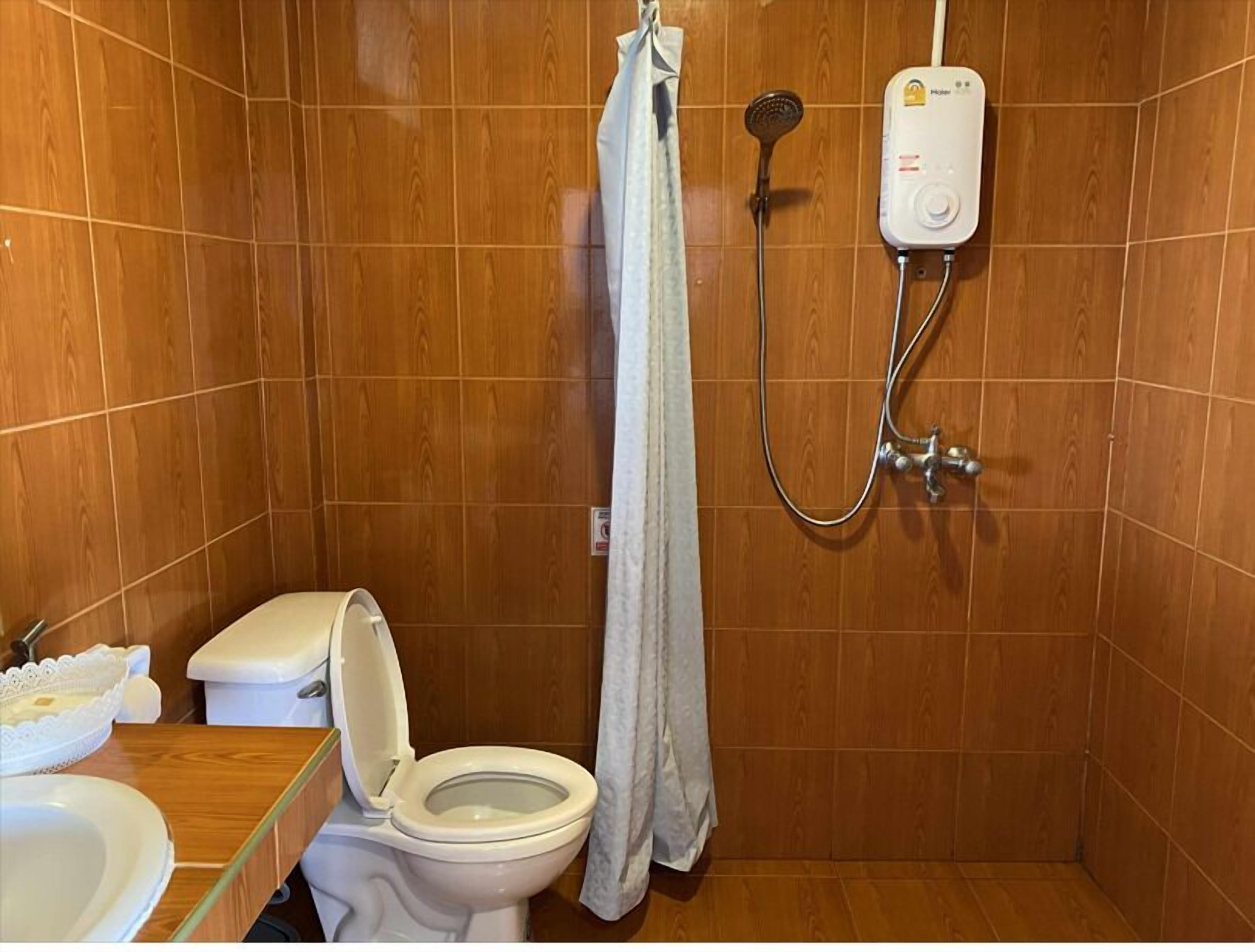 A bathroom with a shower, toilet, and sink.