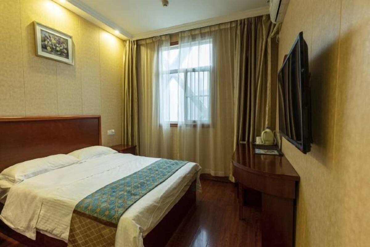 Relax in comfort with a large bed, a convenient nightstand, and a TV for entertainment.