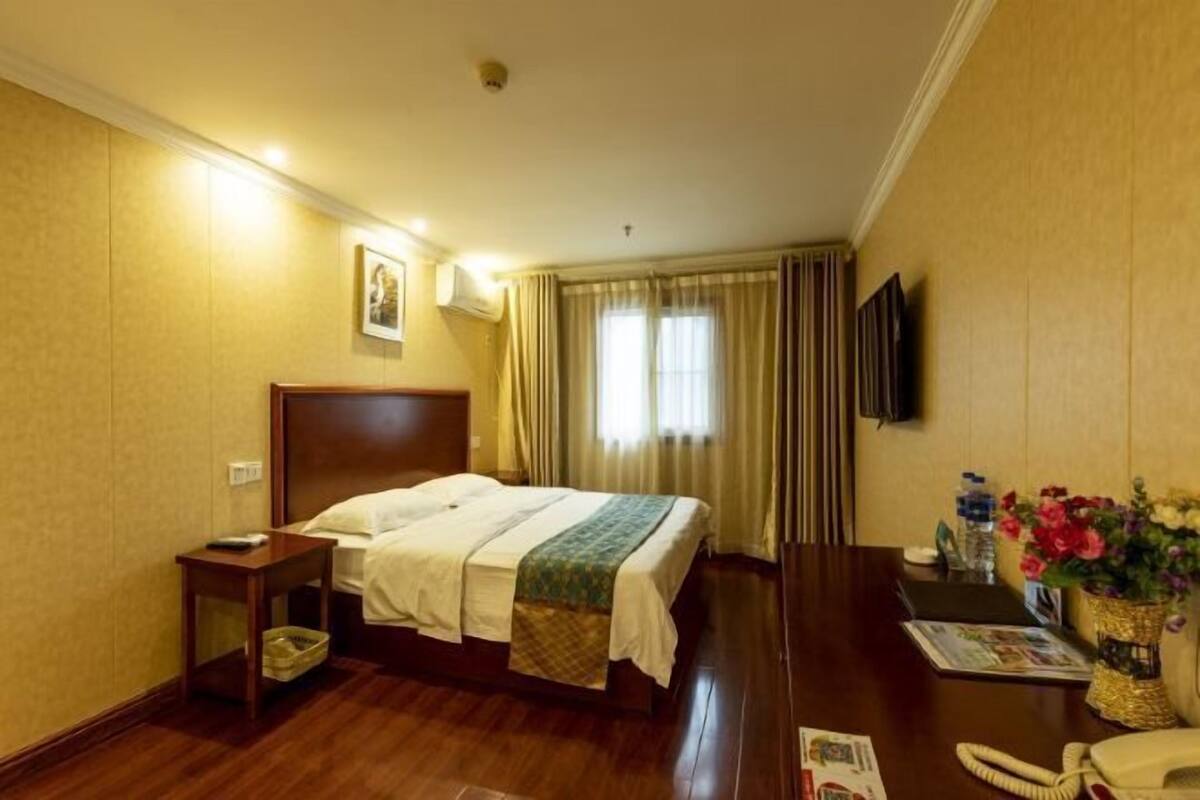 Relax in this inviting space with a comfortable bed, bedside table, and flat-screen TV.
