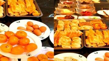 A buffet with various food items including pastries, fruits, and vegetables.
