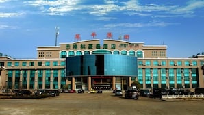 A hotel with a modern facade, large windows, and a prominent entrance. - Greentree Inn Rizhao Yantai Road (Rizhao)
