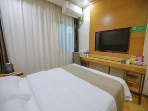 A hotel room with a bed, a desk, a television, and an air conditioning unit. - Greentree Inn Hefei Huainan Road Huaihe Garden (Hefei)