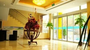 A hotel lobby with a staircase, a reception desk, and large windows. - Greentree Inn Shandong Dezhou Qihe County Party Committee Qilu Street Express Hotel (Dezhou)