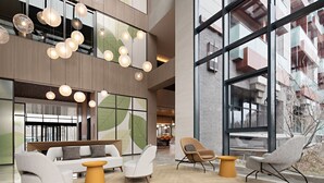 A spacious lobby with a modern design, featuring a seating area with sofas and armchairs, a wooden coffee table, and a large window offering a view of the outside. - Hyatt Place Beijing Shiyuan (Yanqing)