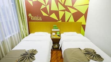 A hotel room with two beds, a wooden floor, a wall with geometric patterns, and a minibar.