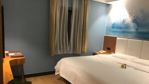 A hotel room with a bed, a desk, a telephone, and a window with curtains. - Greentree Inn Jiangyin Zhouzhuang Shiji Avenue Business Hotel (Wuxi)