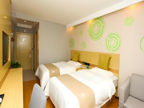 A hotel room with two beds, a desk, and a chair. There are green circular wall decals on the wall. - Greentree Inn Suzhou Changshu Southeast Development Zone Southeast Avenue (Suzhou)