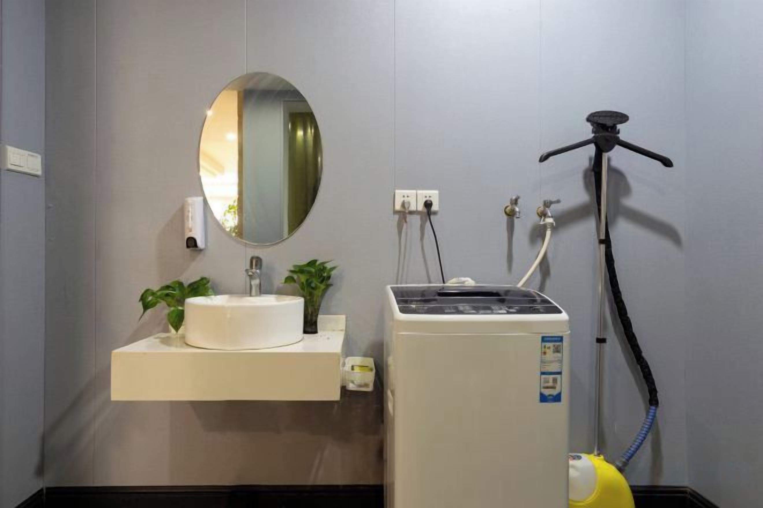 A bathroom with a sink, mirror, and a portable water heater.