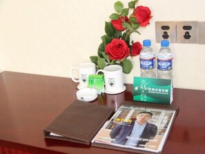 Relax in style with a comfortable seating area featuring a wooden table, a book, and a magazine.