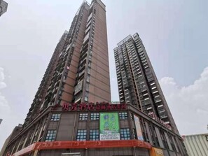 A high-rise building with multiple floors, featuring a prominent sign in the center. - Shell Hefei Yaohai Distrct Baida Zhougudui Daxing Road Hotel (Hefei)
