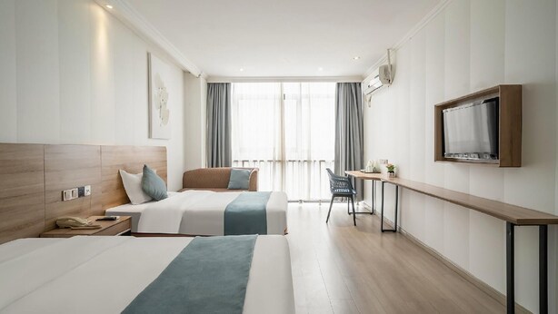 A hotel room with two beds, a desk, a chair, a TV, and a large window with curtains. - Greentree Inn Suzhou Huqiu West Chengbei Road Fulin Square Express Hotel (Suzhou)