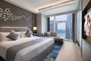 A modern hotel room with a large bed, a seating area, a city view, and a flat-screen TV. - Ascott Xiangjiang FFC Changsha (Changsha)