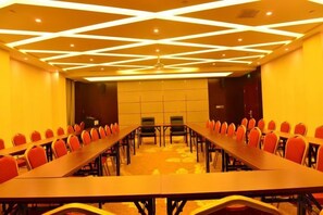 A conference room with a long table and chairs, a patterned ceiling, and a carpeted floor. - Min Le Long Xin Hotel (Minle)
