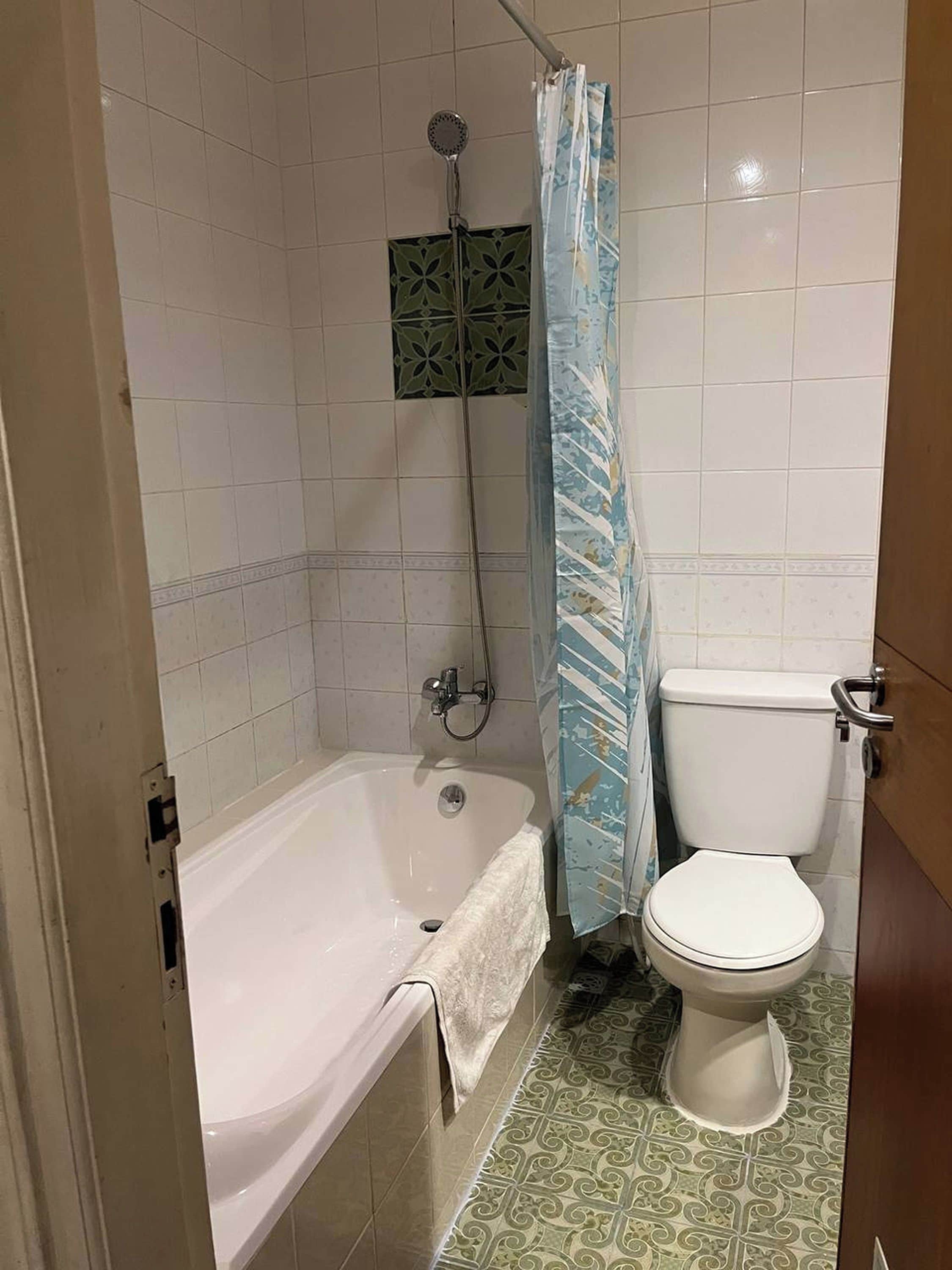 Une salle de bain avec une baignoire, des toilettes et une douche.