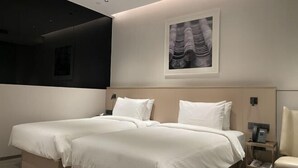 A modern hotel room with two beds, a large artwork on the wall, and a bedside table with a phone. - MeiChen Hotel( within the terminal building of Beijing Daxing International Airport) (Beijing)
