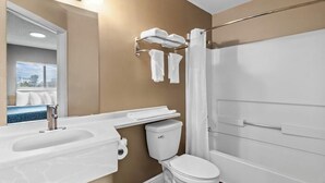 A modern bathroom with a sink, toilet, and shower. - Suburban Studios Stuart Near Federal Hwy 1 (Stuart)