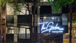 A hotel named "The Garden Capsule Hotel" with a sign above the entrance. - The Garden Capsule Hotel (Da Nang)