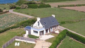 A house with a large garden and a view of the sea.