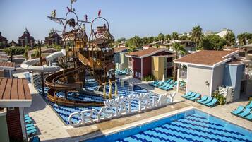 Relax by the pool surrounded by a pirate-themed water feature and lounge chairs.