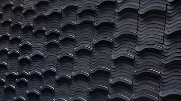 Um close-up de uma superfície texturizada com um padrão repetido de formas curvas.