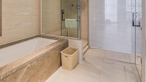 A modern bathroom with a glass-enclosed shower, a freestanding bathtub, and a wall-mounted sink. - Atour Hotel (Shenzhen)